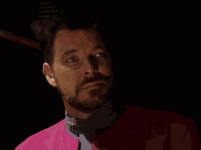 a man with a beard is wearing a pink jacket with the words speak for yourself above him