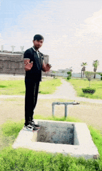 a man in a black shirt is standing on a concrete block in front of a building that says liberty