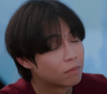 a close up of a person 's face with a red shirt on