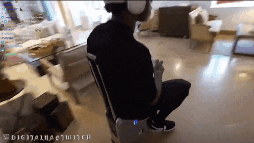 a man is sitting in a chair with a suitcase in front of him and the words digitalna twitch are on the bottom of the screen