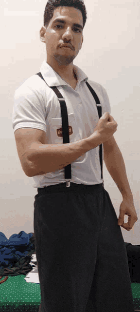 a man wearing suspenders and a white shirt with a red sticker on the pocket that says ' gm '