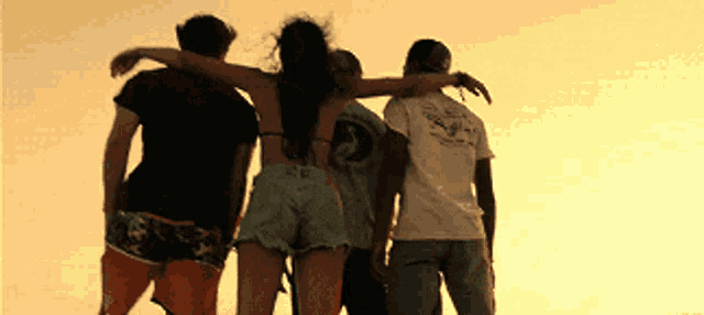 a group of people standing next to each other with one of them wearing a shirt with the number 2 on the back
