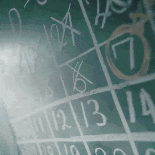 a chalkboard with the numbers 1 through 12 written in white chalk