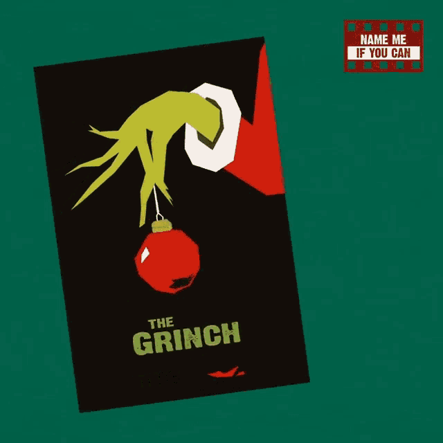 a poster for the grinch with a christmas ornament hanging from it