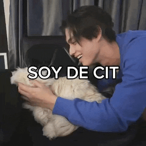 a man is petting a cat with the words `` soy de cit '' written on it .