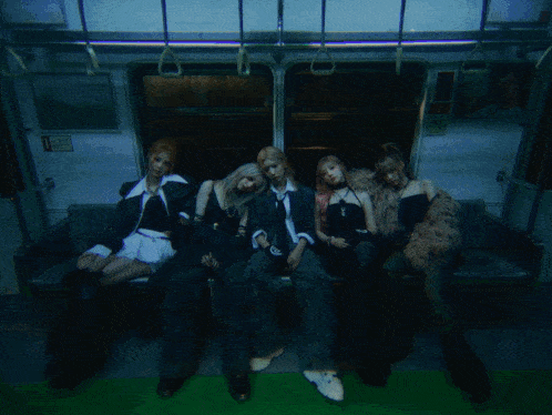 a group of people are sitting on a bus with a sign that says exit on it