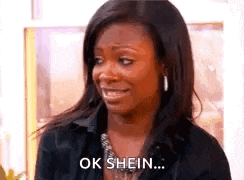a woman in a black shirt is smiling and saying `` ok shein '' .