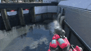 a video game character is holding a gun in front of a waterfall