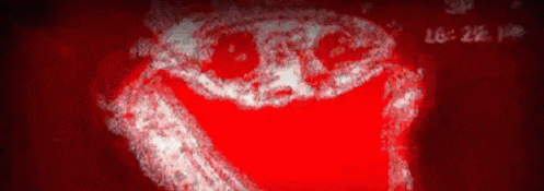 a red background with a white face on it