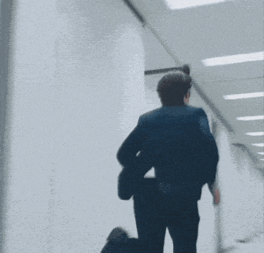 a blurry picture of a man jumping through a door