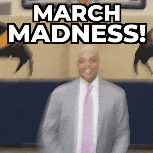 a man in a suit and tie is dancing in front of a sign that says march madness
