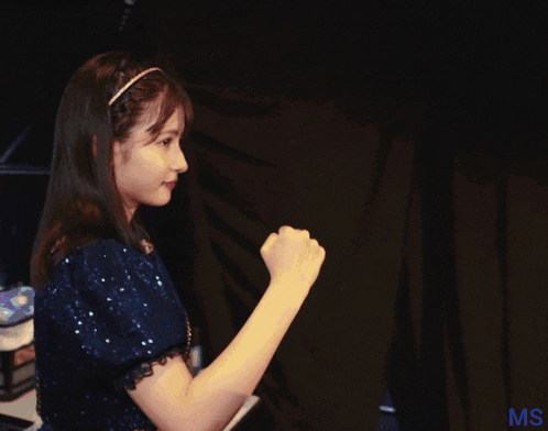 two girls shaking hands in front of a ms sign