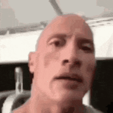 a close up of a bald man 's face .