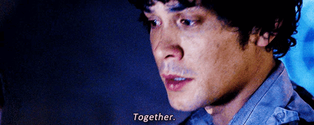 a close up of a man 's face with the words `` together '' written on his face .