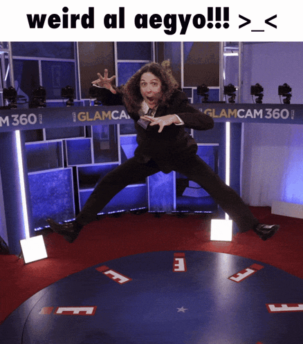 a man in a suit is jumping in the air with the caption weird al aegyo