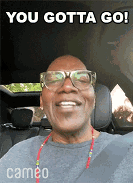 a man in a car with the words you gotta go on the bottom