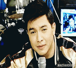 a man holding a microphone with maichardgifs at the bottom