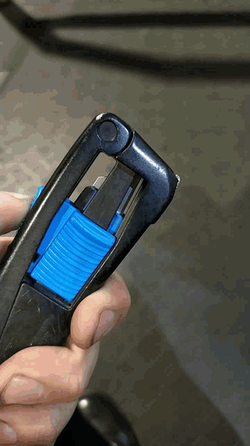 a close up of a person holding a blue and black object
