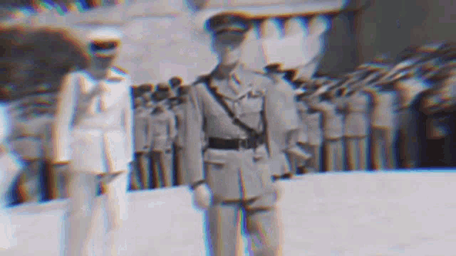 a man in a military uniform is standing in front of a crowd