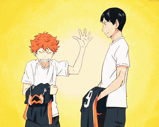 a boy with the number 9 on his shorts is standing next to another boy