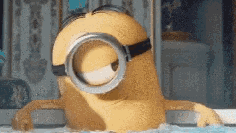 a cartoon minion wearing goggles is sitting in a bathtub .