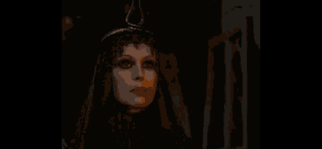 a woman in a black dress and hat is standing in the dark looking up .