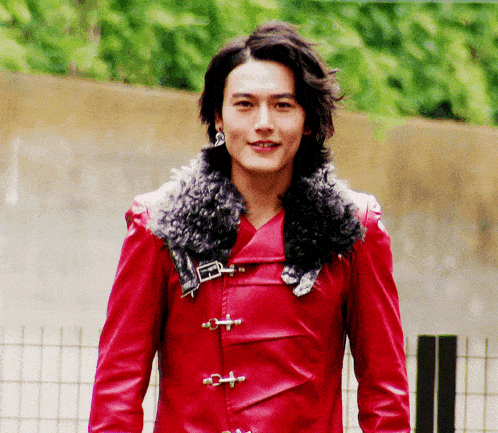 a young man wearing a red leather jacket with a fur collar