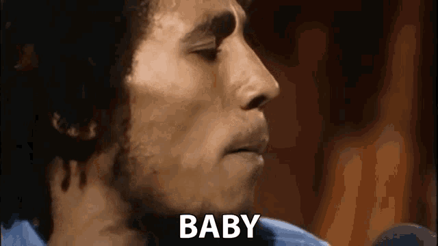 a close up of a man 's face with the word baby written next to him