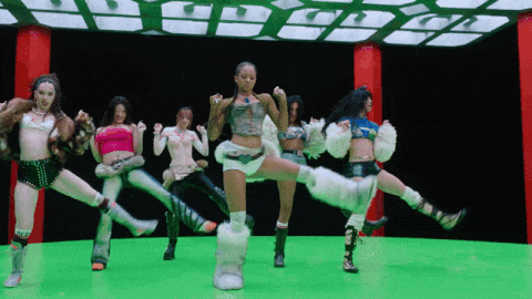 a group of women are dancing together on a green screen