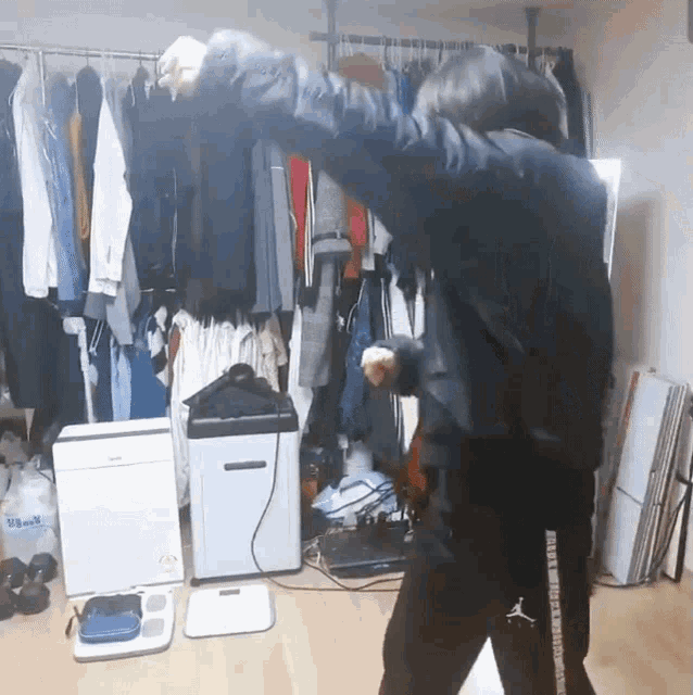 a person wearing a pair of jordan pants is standing in front of a closet