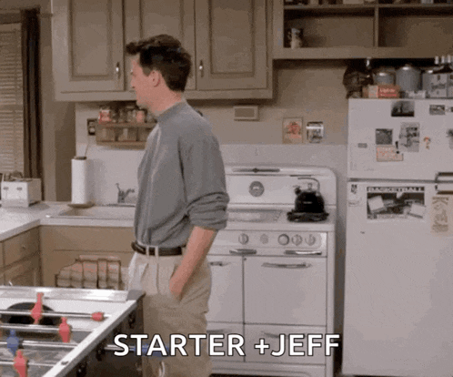a man standing in a kitchen with the words starter + jeff on the fridge