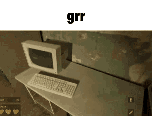 a computer monitor sits on a desk next to a keyboard with the word grr above it