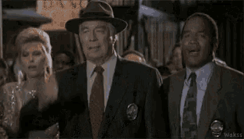 a group of men in suits and ties are standing next to each other in front of a crowd .