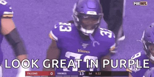 a football player wearing a purple jersey is standing on a field with the words `` look great in purple '' .