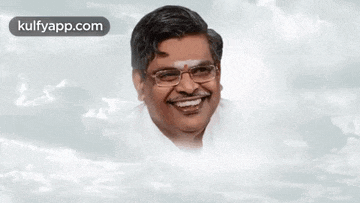 a man wearing glasses is smiling in front of a cloudy sky