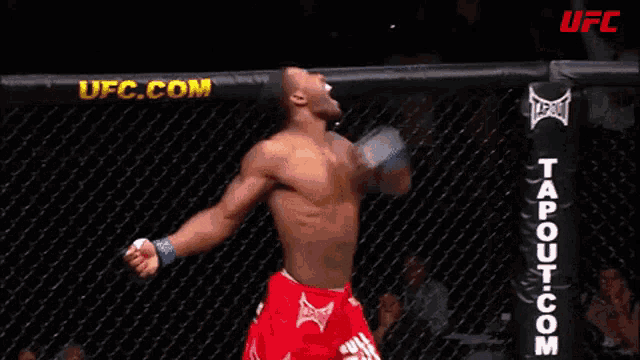 a man in a boxing ring with a ufc.com banner in the background
