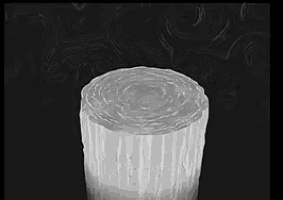 a black and white photo of a glass with a circular pattern on it