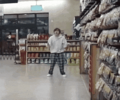 a person is dancing in a grocery store