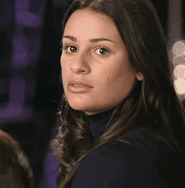 a close up of a woman 's face with a turtleneck