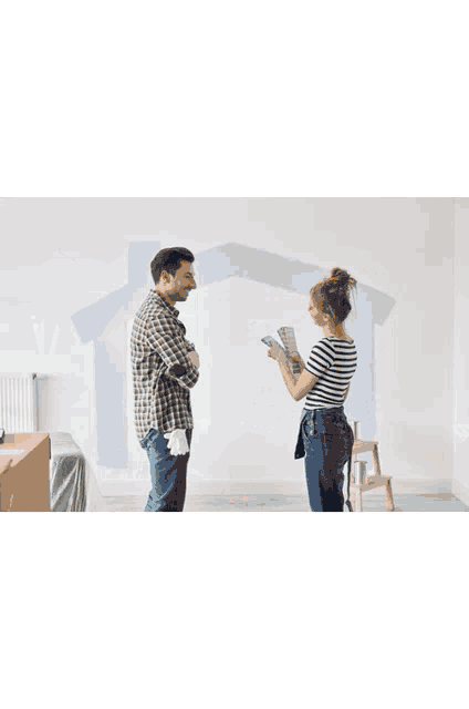a man is painting a wall in a room