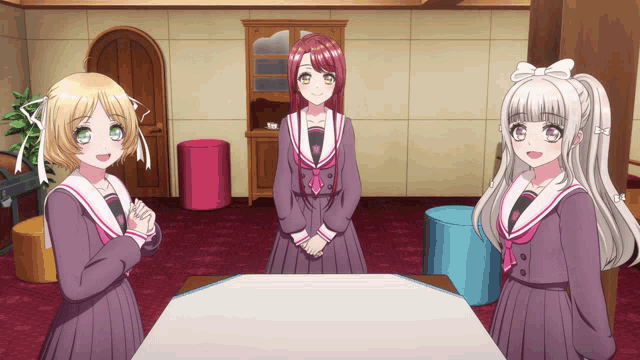 three anime girls are standing around a table in a living room