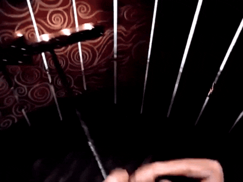 a man with long hair is wearing headphones while sitting on a chair .