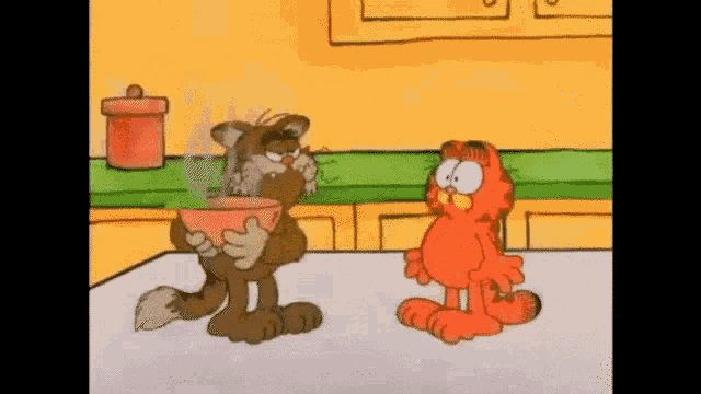 garfield and a cat are standing next to each other in a kitchen . garfield is holding a bowl of hot soup .