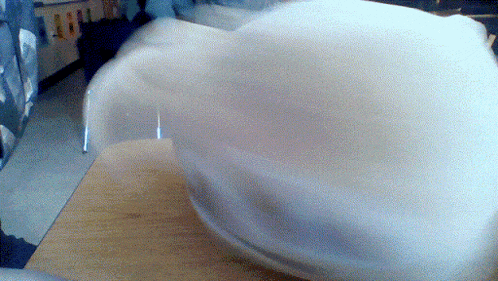a white object is spinning on a table
