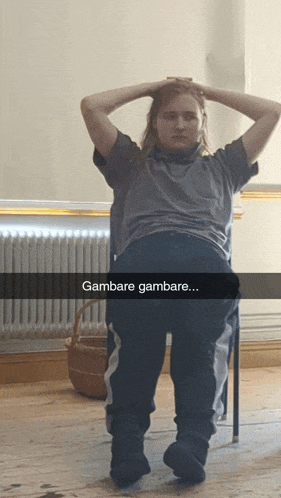 a person sitting in a chair with the words gambare gambare written on the bottom