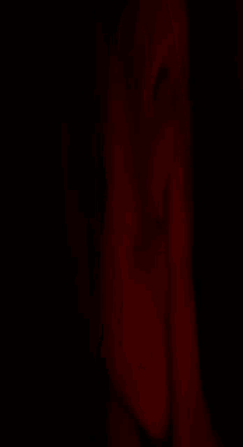 a close up of a person 's face in a dark room