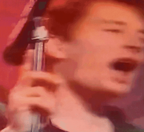a blurry picture of a man holding a microphone