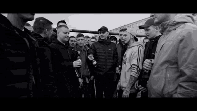 a black and white photo of a group of young men standing together