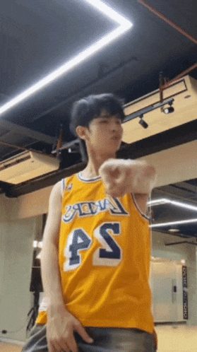 a young man wearing a yellow jersey with the number 45 on it