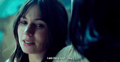 a woman is crying and saying `` i am here and i stay '' in front of a mirror .